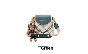 Detail of green and beige quilted crossbody phone bag with cute bunny doll charm
