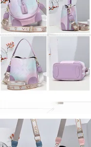 Detail of gradient rainbow bucket bag with branded woven shoulder strap and metal hardware