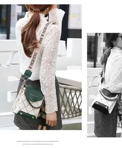 Close-up of stylish mini crossbody bag with diamond quilting and wide logo strap