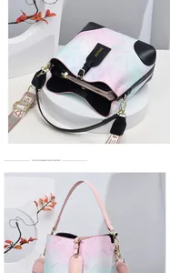 Close-up of a gradient bucket bag with floral patterns and a detachable shoulder strap