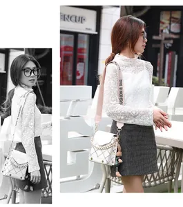 Detailed view of white quilted crossbody bag with gold hardware and pink fashion strap