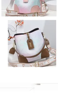 Detailed view of the gradient pink to blue leather surface with star pattern and wide strap