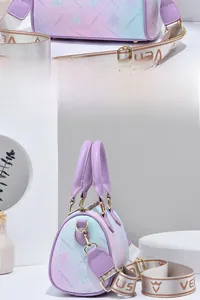 Detail of gradient crossbody bag featuring floral pattern and VENUS woven strap