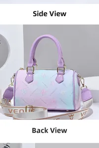 Detail view of pink and blue gradient Boston bag with floral print and purple leather handle