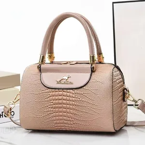 Elegant crocodile pattern Boston handbag in nude pink with golden kangaroo metal logo detail