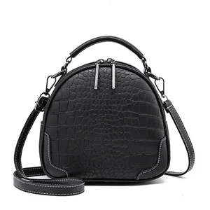 Black crocodile embossed leather crossbody bag with top handle and silver hardware zippers