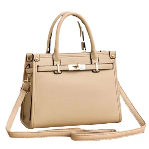 Classic beige pebbled leather Kelly style handbag with gold hardware and shoulder strap