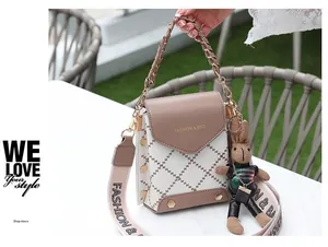 Detail of mini crossbody bag with plaid pattern, metal chain handle and cute rabbit charm