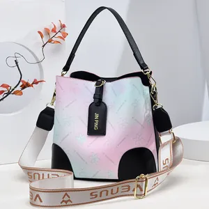 Gradient rainbow bucket bag with floral patterns and a wide woven detachable shoulder strap