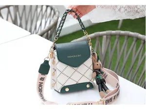 Detail of green and white patchwork crossbody bag with plush rabbit charm and gold studs