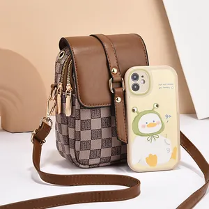 Vintage brown leather crossbody phone bag with stylish gold hardware and letters
