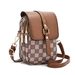 Brown checkered crossbody cell phone bag with three zippers and golden rivets