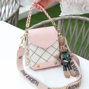 Pink and white quilted crossbody bag with golden studs and a cute plush rabbit charm
