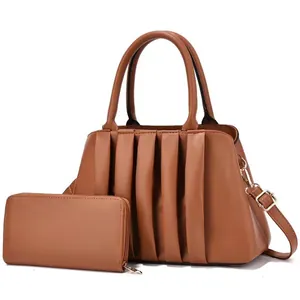 Close-up of caramel brown pleated shoulder bag and matching zip-around long wallet set