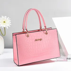 Pink crocodile pattern tote bag with gold logo and elegant handles for women