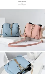 Detail of cross-grain leather texture with metal cat charm and tassel on trendy bucket bags