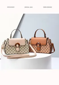 Detail of vintage monogram printed handbags with wooden buckle and leather shoulder straps