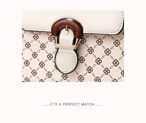 Detail of elegant printed handbag featuring vintage pattern and wooden buckle closure