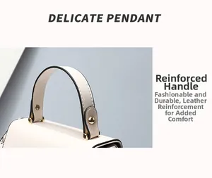 Detail of the reinforced leather handle and golden hardware on the beige handbag