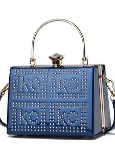 Navy blue patent leather evening handbag with gold handles and koi koi stud pattern