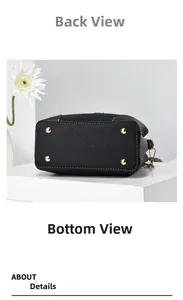 Detail view of the black bucket bag bottom with gold protective studs and fine stitching