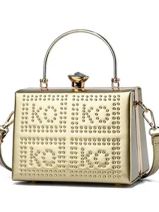 Gold hard-shell evening clutch bag with KOI KOI stud letters and faux diamond top handle