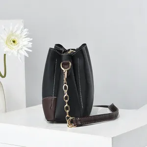 Chic cross-grain leather bucket bag with contrast stitching and gold chain strap