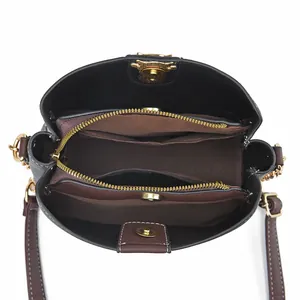 Deep brown bucket bag with internal multi-compartment layout and dual zipper pockets