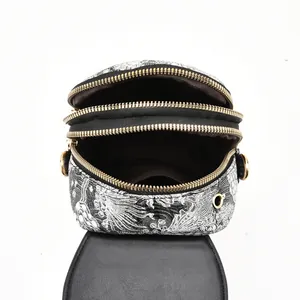 Detailed view of the three-layered zipper compartments and vintage ethnic print fabric