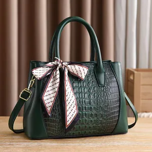 Dark green crocodile texture tote bag with silk scarf handle and gold hardware detail
