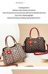 Detail of checkered shoulder bags with red heart charms and removable gold hardware straps