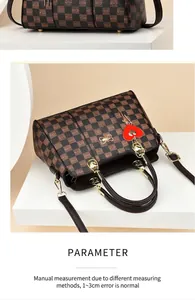 Detail view of checkered handbag base with gold studs and adjustable shoulder strap