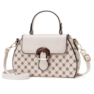 Elegant cream crossbody handbag with black clover pattern and wooden buckle handle