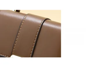 Close-up of brown leather bag featuring precise reinforced stitching and smooth edge oil