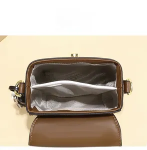 Internal view of the brown crossbody bag showing dual large capacity compartments
