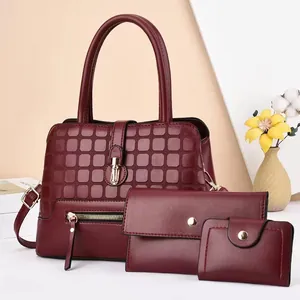 Three-piece burgundy women's bag set with textured tote, clutch and card holder
