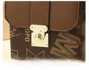 Detail of a vintage pattern mini square bag featuring a gold metal twist lock closure
