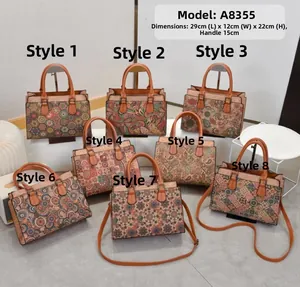 Detailed view of large printed crossbody handbags with dimensions 29x12x22cm and dual handles