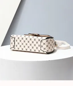 Detail shot of the reinforced black edge trim and base of the printed crossbody bag
