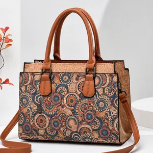 Detail of crossbody bag with cork texture and retro mandala floral print on white stand