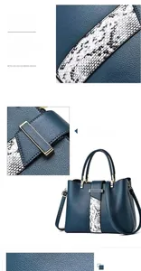Detail of snake skin texture and golden hardware on the navy blue leather tote bag