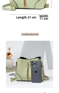 Size comparison of green quilted bucket bag with gold chain and mobile phone