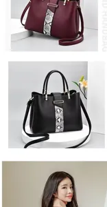 Detail of burgundy and black pebbled leather tote bags with snakeskin accents and metal buckle