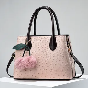 Pink ostrich pattern tote bag with brown handles and a cherry plush charm decoration