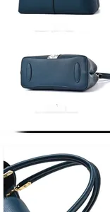 Detail view of navy blue pebbled leather tote showing rear view and bottom protective studs