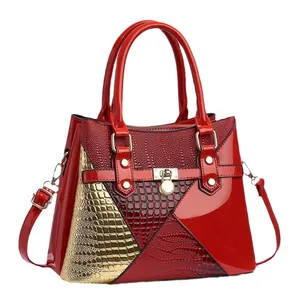 Red multi-texture patchwork handbag with gold-tone hardware and top handle for women