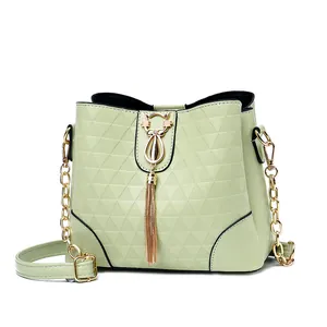 Mint green bucket bag with triangle embossed pattern and gold cat tassel ornament