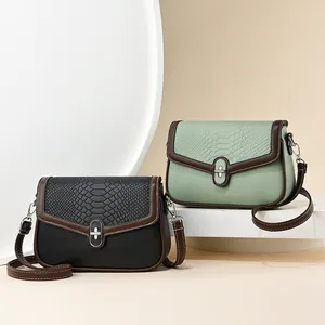 Vintage crossbody square bag with snake pattern flap in black and sage green colors