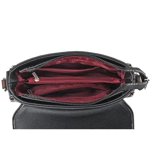 Functional interior of black textured crossbody bag with red lining and zippered pocket