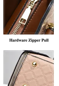 Detail des goldenen Reißverschluss-Schiebers und der gesteppten Textur der Handtasche